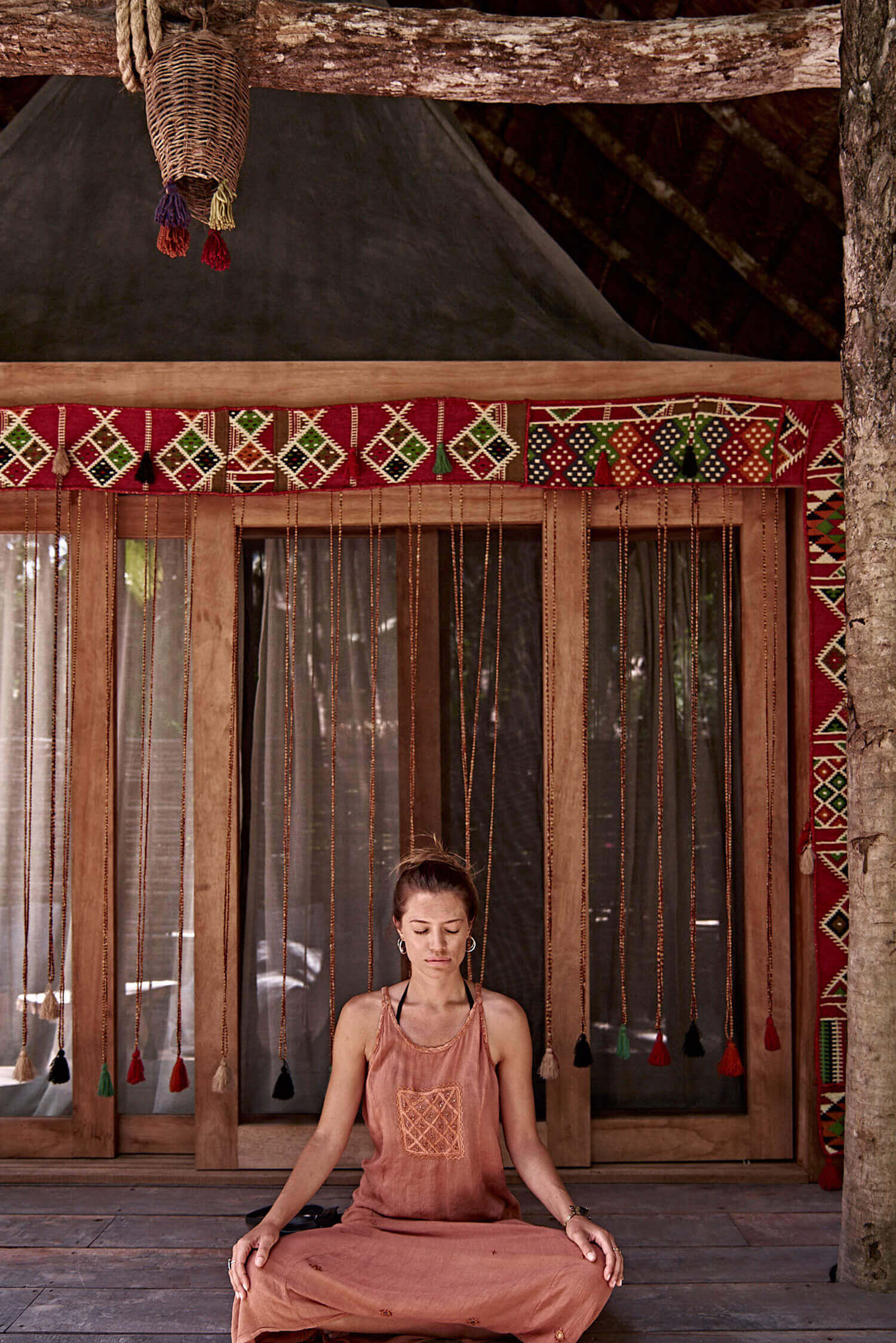 woman practicing yoga at nomade Tulum