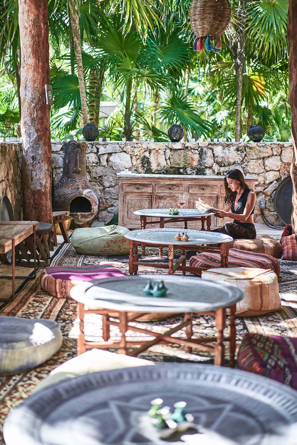 woman reading a book in the rest area at nomade Tulum